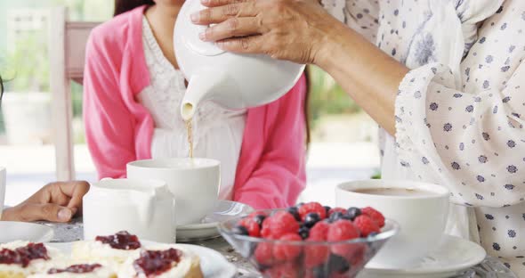 Multi-generation family having having tea 4k