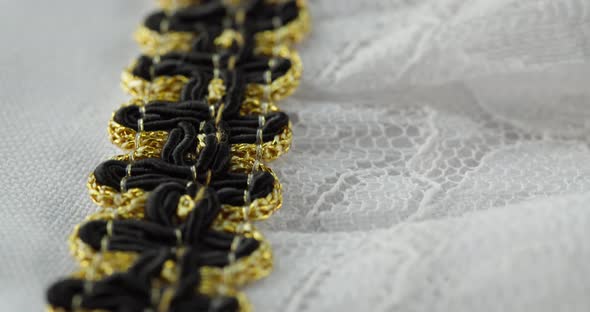 White Lace with Black and Golden Decor Closeup