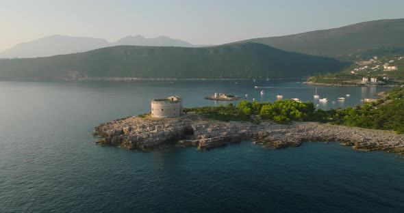 moving away from fort arza and Otocic Gospa island with boats and yachts on background