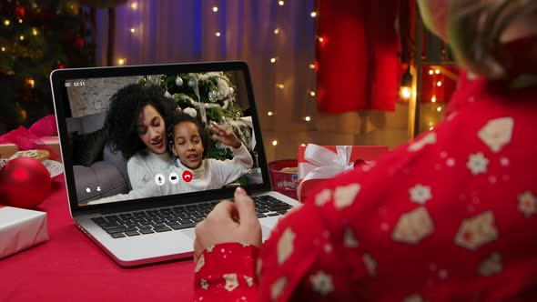 Online Video Calling of Happy Smiling African American Mom and Little Daughter Wishing Merry