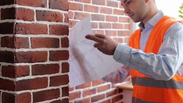 A builder engineer makes measurements of the premises in the building.