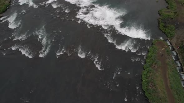 Aerial flyover of a waterfall in Iceland