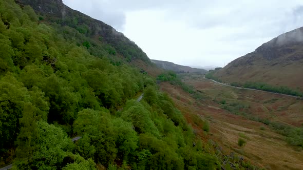 Cinematic fly-over aerial drone shot of scottish highland landscape