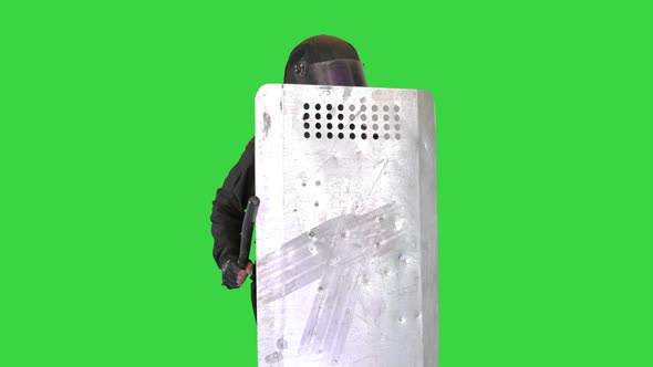 Riot Police Making Noise Hitting His Riot Shield with Baton on a Green Screen Chroma Key