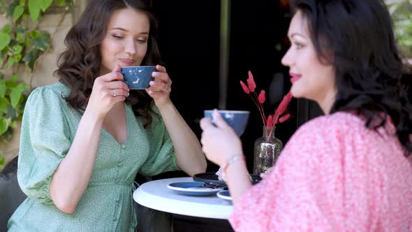 Mother and Daughter are Talking While Sitting at the Table