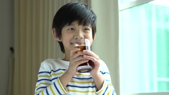 Little Asian Boy Drinking Soft Drink Cola Soda