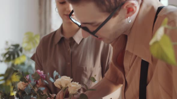 Young Male and Female Florists Making Flower Composition in Hatbox