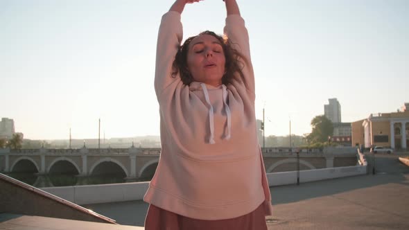Woman Doing Breathing Exercises Outdoors