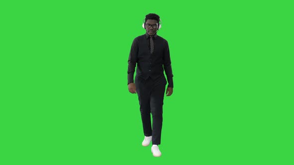 Young African American Man Listening To Music Headphones While Walking Green Screen Chroma Key