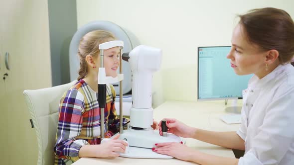 Ophthalmologist Examines the Girl on a Corneo Topographer