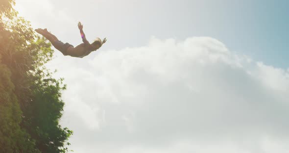 Young man cliff diving