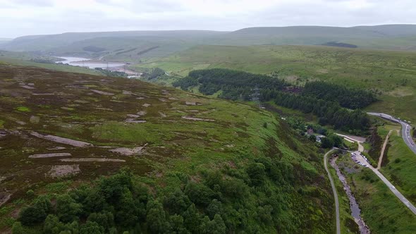 Drone ariel point of view.  Derbyshire Peak District moors showing pathways and reservoir in the dis