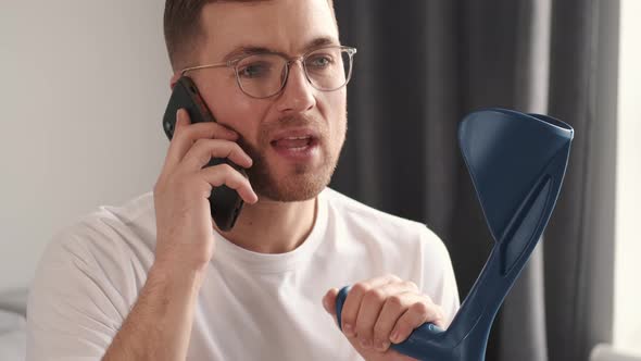 Young Man with Walking Stick Talk By Phone Indoors