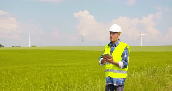 Engineer Using Digital Tablet at Windmill Farm