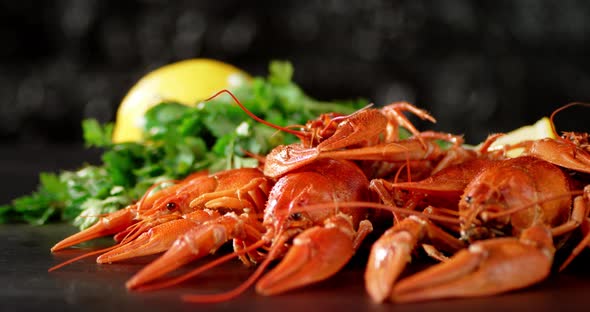 Boiled Crayfish with Herbs and Lemon on the Table Rotate