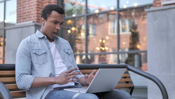 African Man Frustrated by Failure, Sitting on Bench