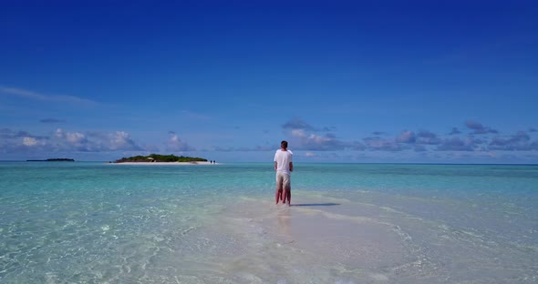 Beautiful man and woman married on vacation enjoy life on beach on sunny white sandy 4K background