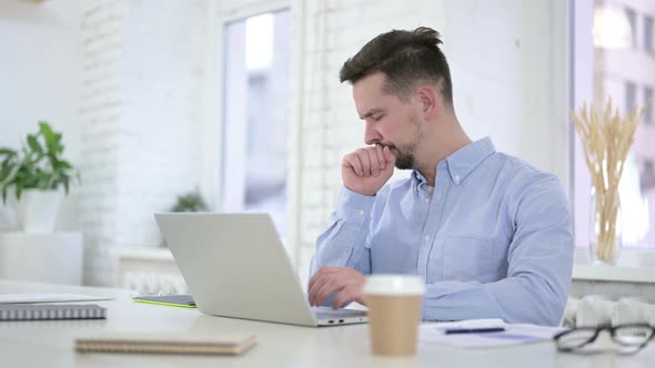 Sick Man Coughing While Working on Desktop