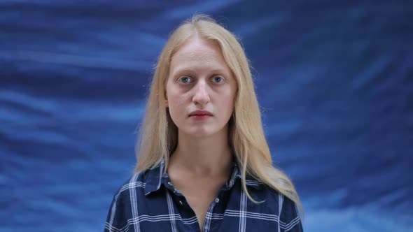 Portrait of Young Woman Wearing Shirt Looking To Camera. Crop View of Serious Female Person with