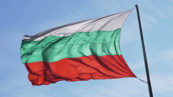 Bulgarian Waving Silk Flag on Flagpole Against Blue Sky