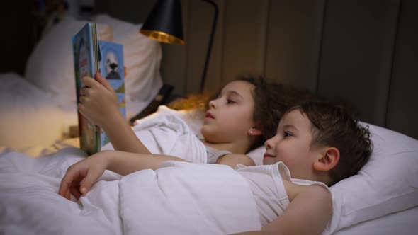 Beautiful Little Sister Takes Care Her Little Brother Before Going to Bedreads Bedtime Story to