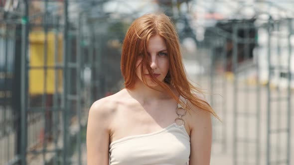 Portrait of Beautiful Smiling Redhaired Woman on Street at Day