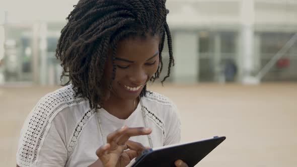 Smiling African American Woman Using Tablet