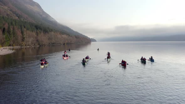 A Team of Canoeists on a Lake in the Early Morning