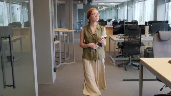 Young Office Worker Walking Along Office