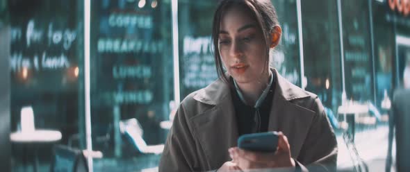 Young woman typing on smartphone