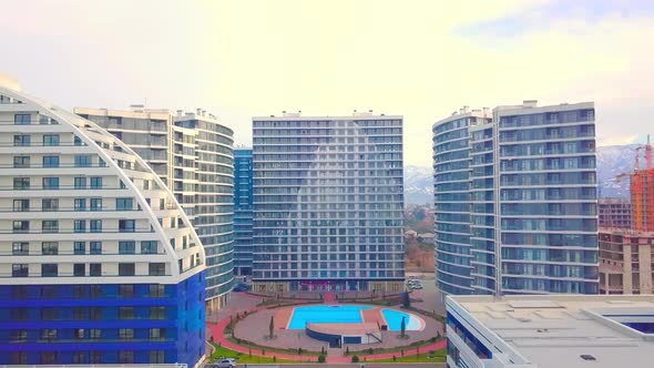 Urban development of multi-storey buildings with a swimming pool aerial view.