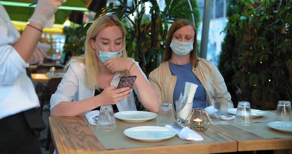 Restaurant Visitors in Sterile Facial Masks on Terrace