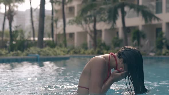 Woman Cleans Face and Fixes Hair in Pool Slow Motion