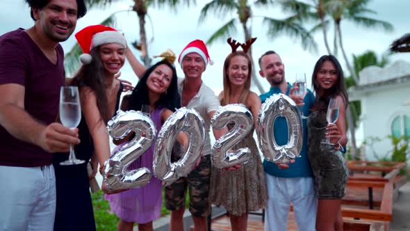 Group of Happy People of Mixed Race Friends Celebrate Christmas and New Year