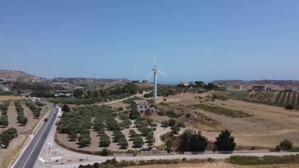 Aerial view: wind turbine on Mediterranean farm hilltop, Europe