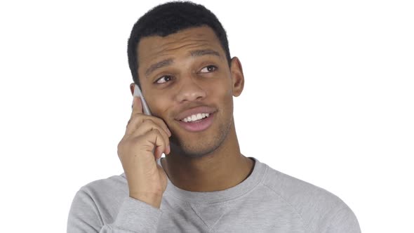 AfroAmerican Man at Work Talking on Smartphone with Customer