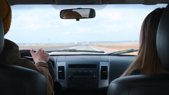 A Young Couple Travels By Car