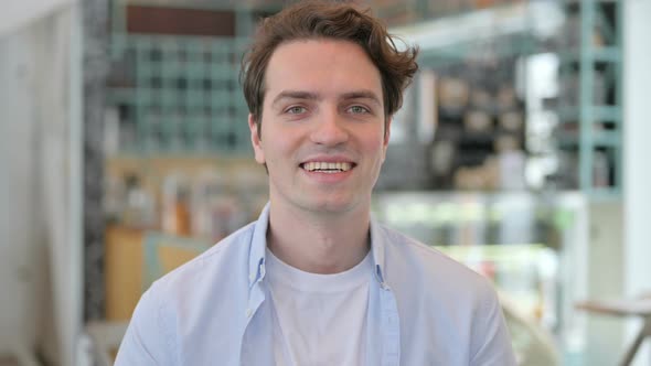 Portrait of Young Man Smiling at Camera