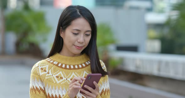 Woman use of smart phone in city