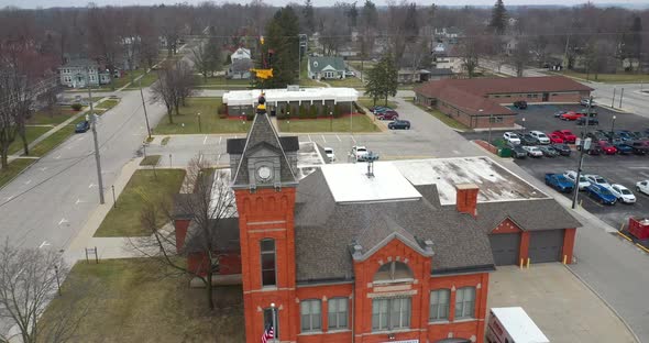 Antique fire station in Ithaca, Michigan with drone videoing down.