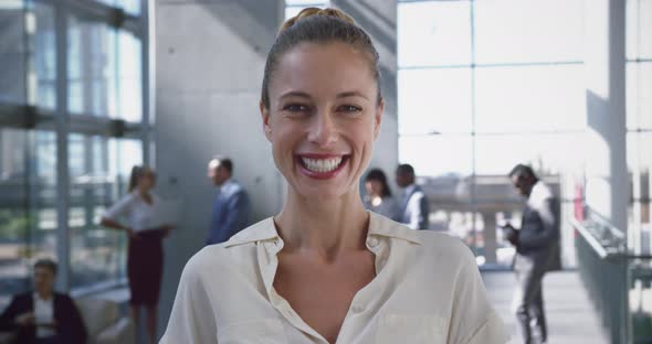 Businesswoman looking at camera in the lobby at office 4k