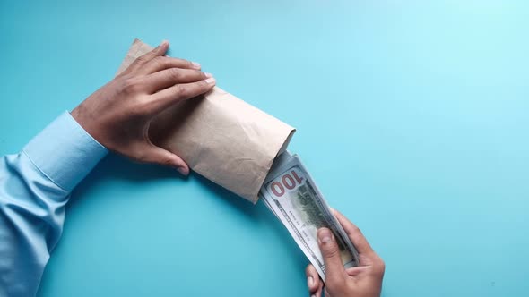 Person Hand Putting Cash in a Envelope