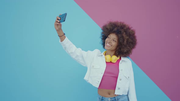 Beautiful young woman with curly hairstyle and fashionable clothes