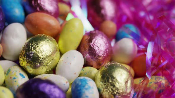 Rotating shot of colorful Easter candies on a bed of easter grass - EASTER