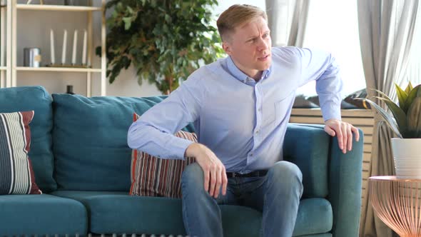 Casual Middle Aged Man Standing and Leaving Couch