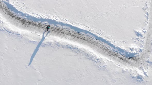 Woman is skating on frozen lake in winter