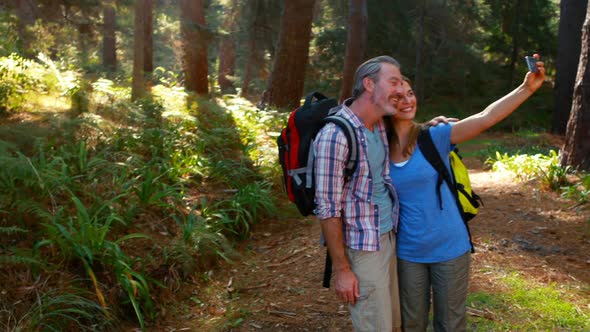 Happy hiker taking selfie from mobile phone