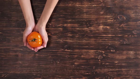 Invisible Person Arms with Yellow Tomato