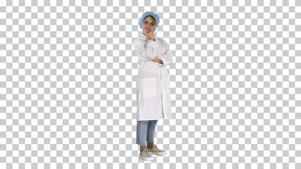 Smiling confident young woman doctor standing with arms