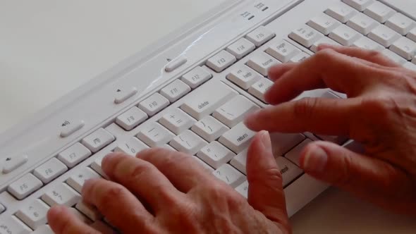 Busy hands working and typing on a computer keyboard.